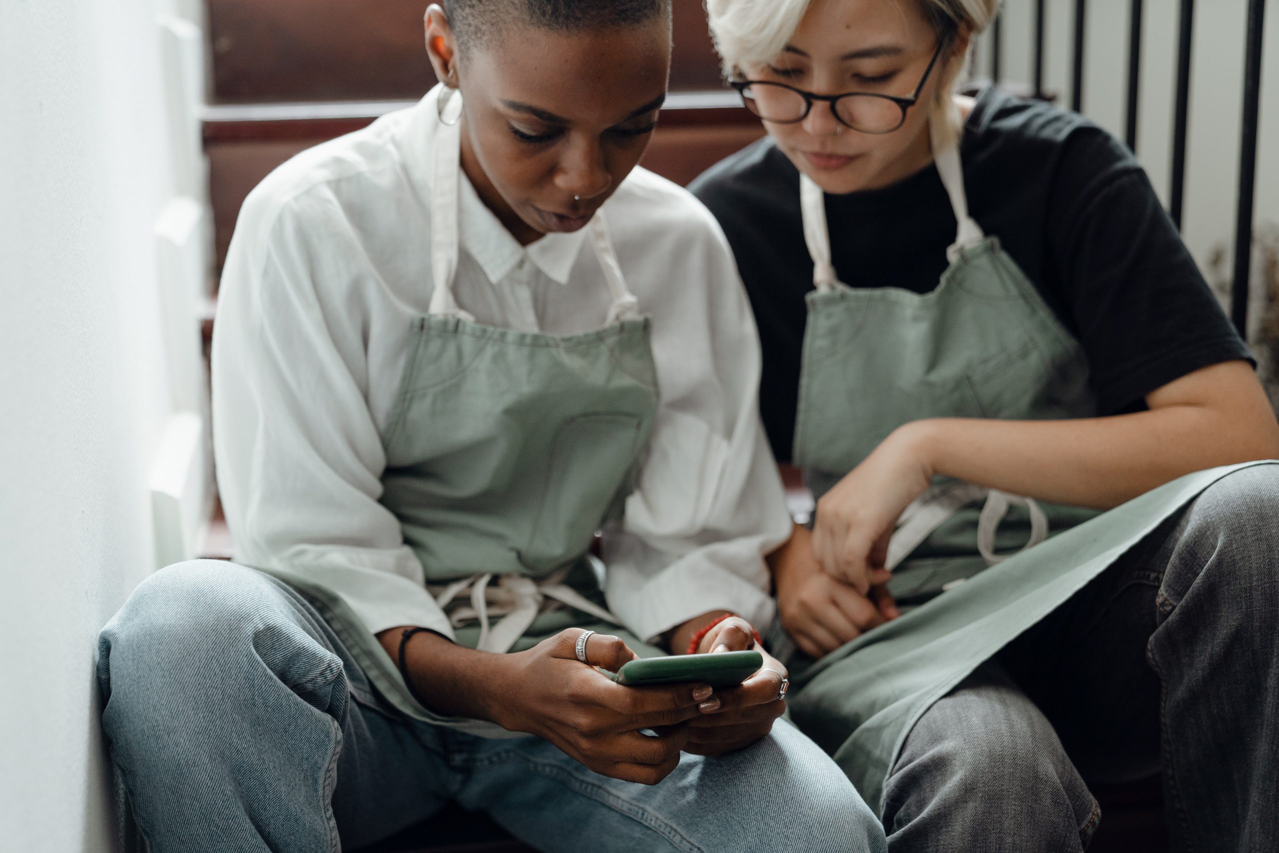 Two people view an explainer video on a mobile phone