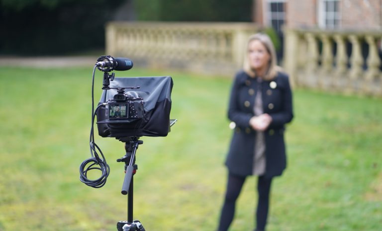 A behind the scenes photo of a property sales video being filmed