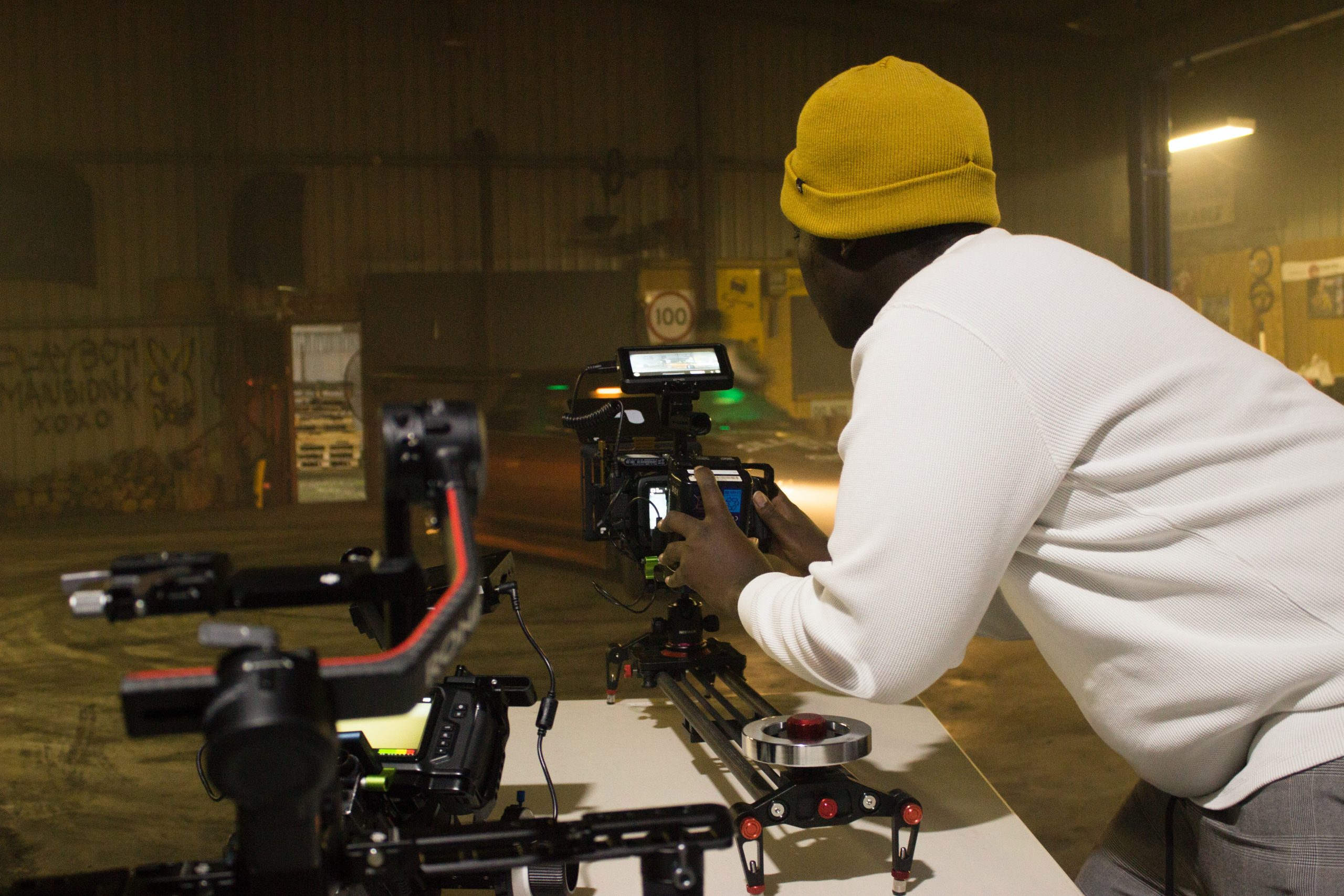 Image shows behind the scenes content of a man filming
