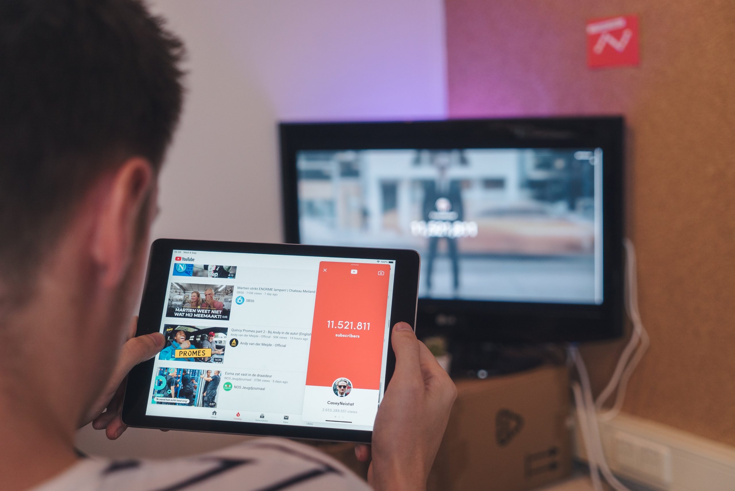 Image shows a man watching YouTube shoppable videos on a tablet