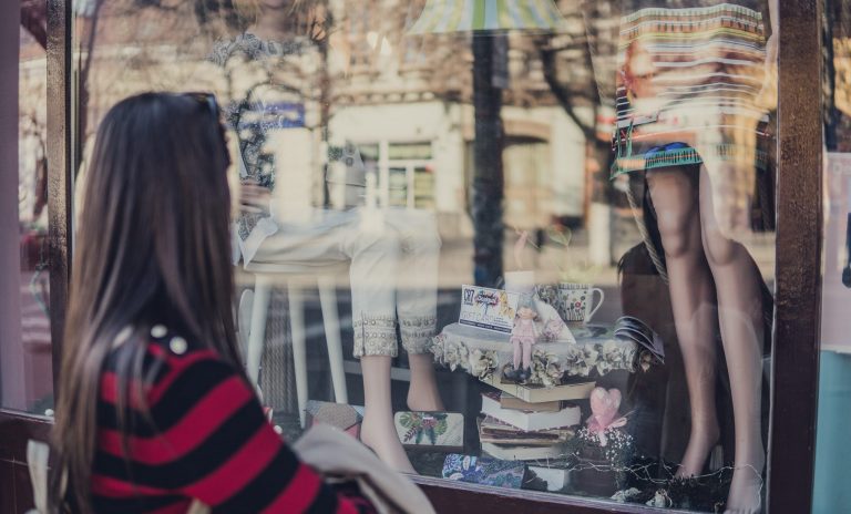 Image shows a woman window shopping