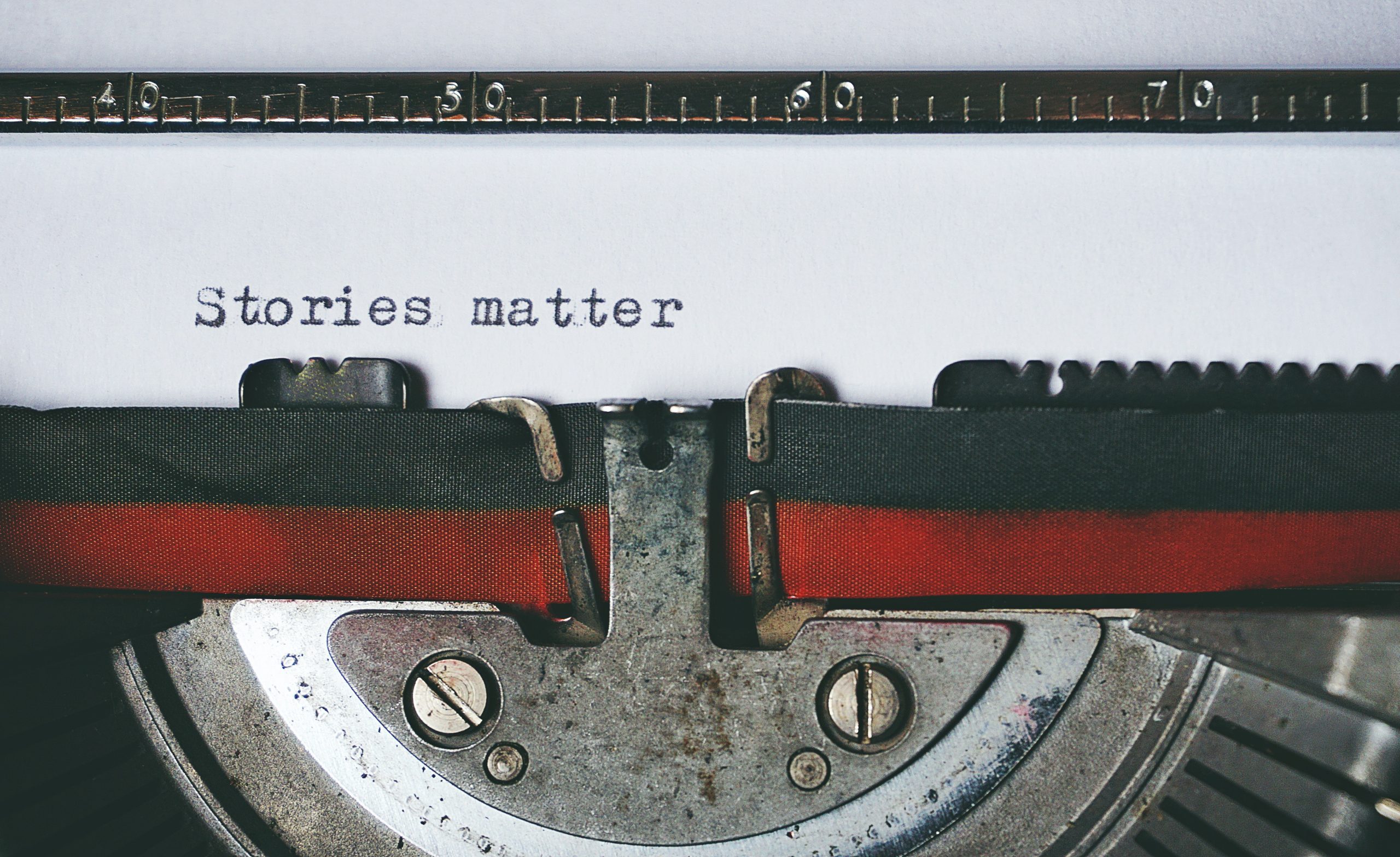 Image shows a close up of a typewriter with the phrase "stories matter" typed onto a piece of paper.