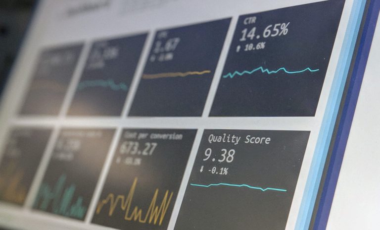 Image shows a laptop screen with various KPIs data being analysed.