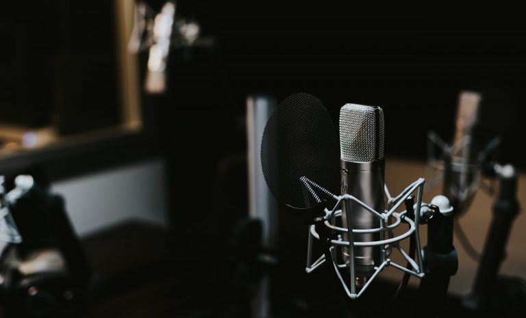 Video podcast studio with microphone and desk chair